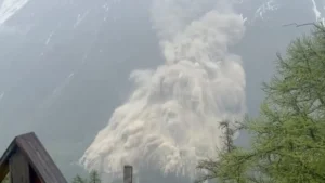 Aerial view of the Birch Glacier collapse in Switzerland, showing massive ice fractures and debris covering the village of Blatten.