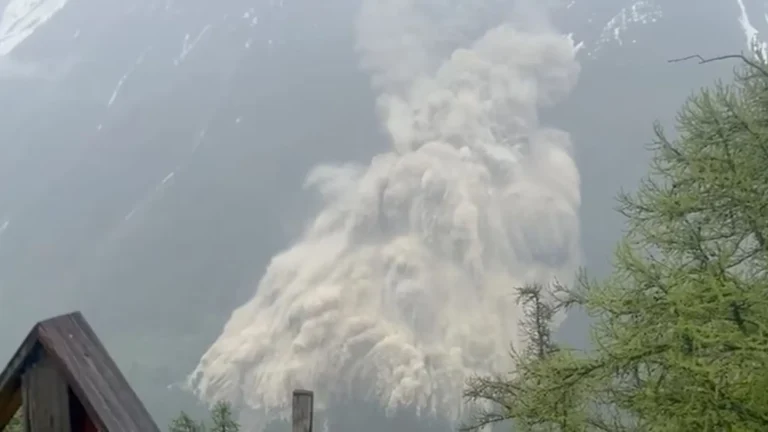 Aerial view of the Birch Glacier collapse in Switzerland, showing massive ice fractures and debris covering the village of Blatten.