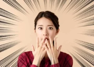 A shocked woman reacting to the influencer scandal, symbolizing the hidden truths behind social media manipulation.